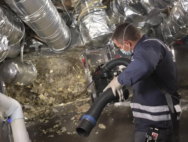 North Reading Air Duct Cleaning specialist operating negative pressure cleaning equipment for thorough duct maintenance in North Reading