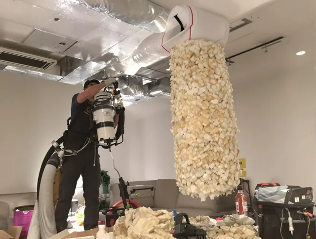 North Reading Air Duct Cleaning technician performing precision vacuum insulation removal in a residential property in North Reading
