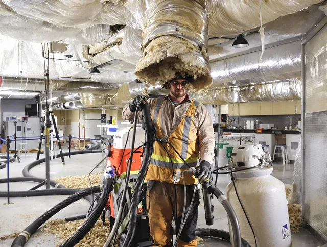 Professional vacuum insulation removal by North Reading Air Duct Cleaning expert in North Reading